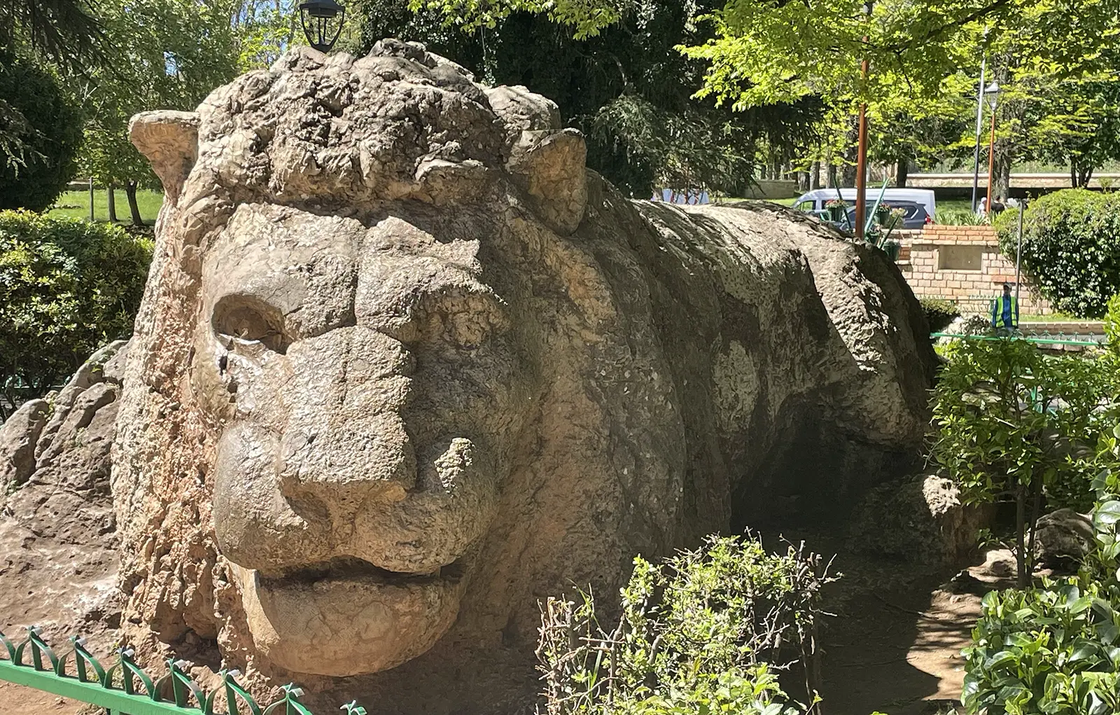 A stone lion sculpture in a garden